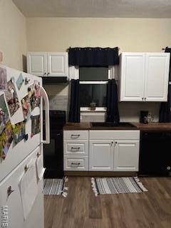 200 N Madison St, Kinmundy, IL 62854 - kitchen with dishwasher, white cabinetry, and dark wood-style flooring