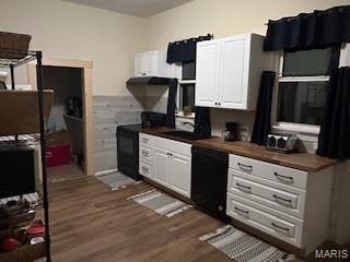200 N Madison St, Kinmundy, IL 62854 - kitchen featuring dark countertops, dark wood-style floors, black dishwasher, and white cabinets