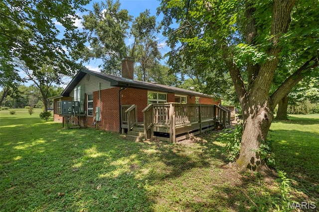 17999 State Highway 177, Jackson, MO 63755 - back of house featuring brick siding, a chimney, a deck, and a lawn