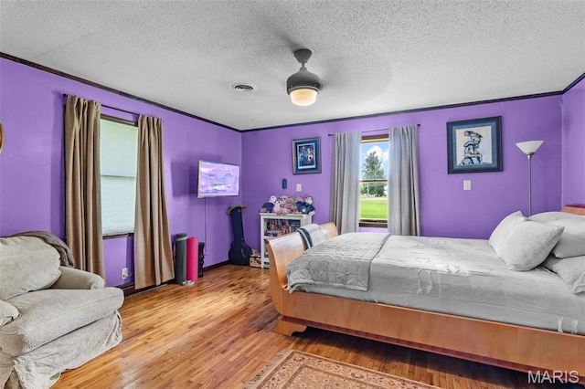 17999 State Highway 177, Jackson, MO 63755 - bedroom featuring wood finished floors, a textured ceiling, crown molding, and a ceiling fan