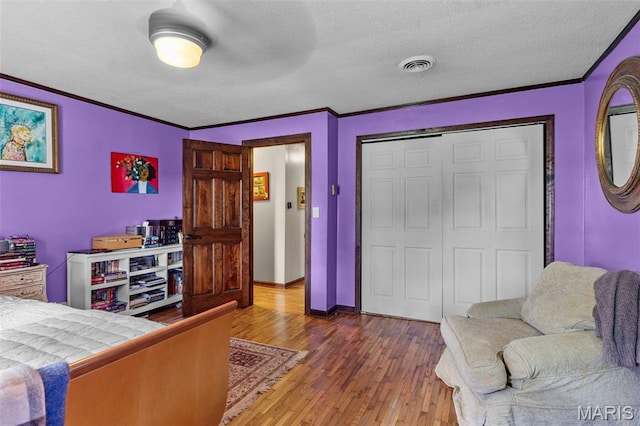 17999 State Highway 177, Jackson, MO 63755 - bedroom with wood finished floors, a textured ceiling, ornamental molding, and a closet