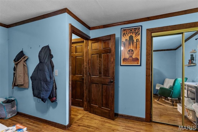 17999 State Highway 177, Jackson, MO 63755 - hall featuring crown molding, light wood finished floors, and a textured ceiling