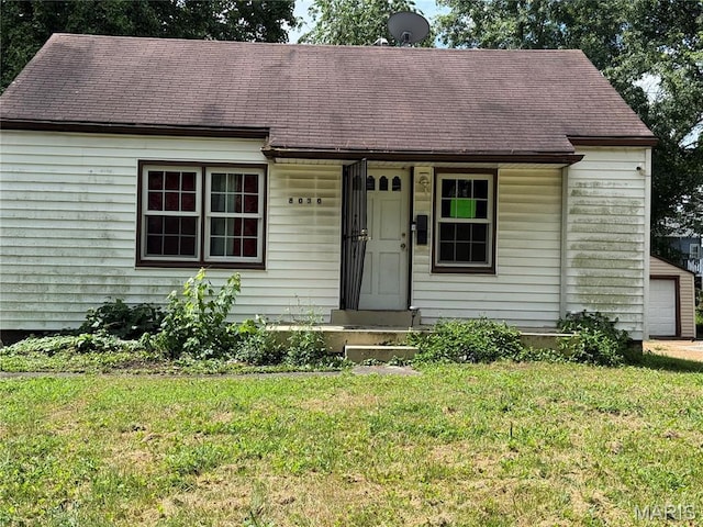 8030 Aline Ave, Berkeley, MO 63134 - view of front of property featuring a front yard, roof with shingles, and a garage