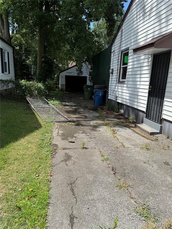 8030 Aline Ave, Berkeley, MO 63134 - view of grassy yard with driveway and an outbuilding