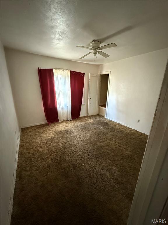 8030 Aline Ave, Berkeley, MO 63134 - unfurnished bedroom featuring carpet flooring and a ceiling fan