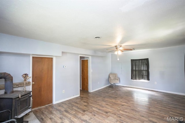 200 S Frisco, Crocker, MO 65452 - unfurnished living room featuring ceiling fan, wood finished floors, and a wood stove