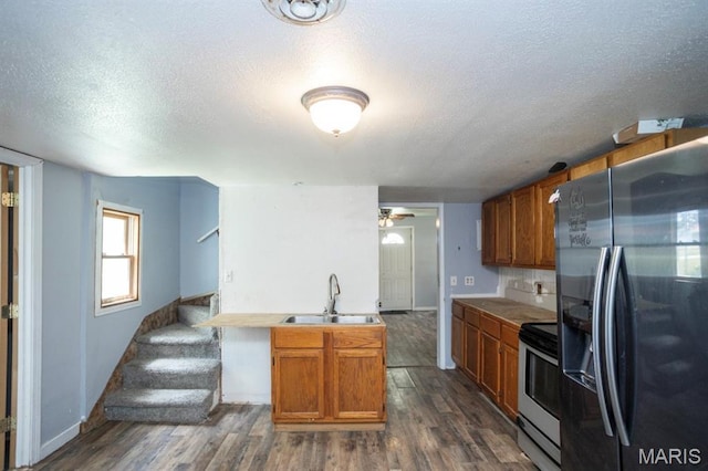 200 S Frisco, Crocker, MO 65452 - kitchen featuring refrigerator with ice dispenser, stainless steel electric range, a textured ceiling, brown cabinetry, and dark wood finished floors