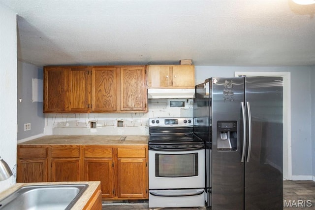 200 S Frisco, Crocker, MO 65452 - kitchen featuring appliances with stainless steel finishes, under cabinet range hood, brown cabinets, and a textured ceiling