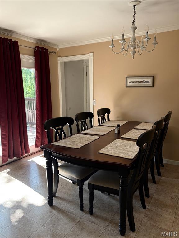2941 Elmcrest Dr, Saint Charles, MO 63301 - dining room with a chandelier, ornamental molding, and tile patterned flooring