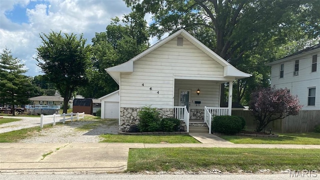464 S Mill St, Nashville, IL 62263 - bungalow-style house with covered porch, stone siding, and a garage