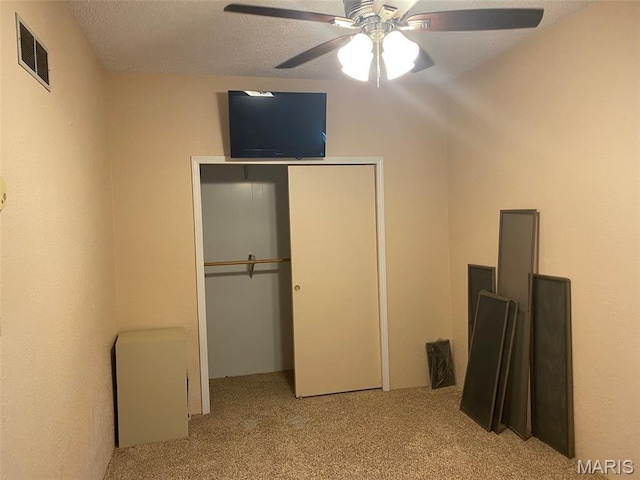 464 S Mill St, Nashville, IL 62263 - unfurnished bedroom featuring carpet, a closet, ceiling fan, and a textured ceiling