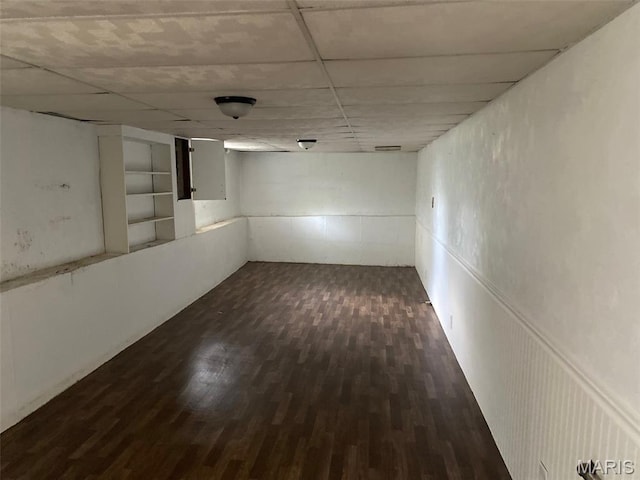 464 S Mill St, Nashville, IL 62263 - finished basement featuring dark wood-style floors, a paneled ceiling, and built in shelves
