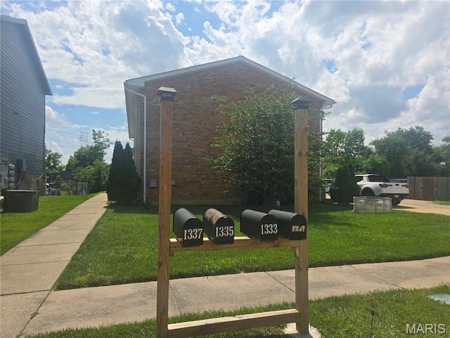 1331 Dartmouth Ct, Saint Charles, MO 63303 - view of property exterior with brick siding and a yard