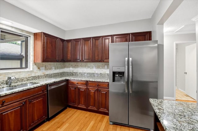 775 Knickerbacker Dr, Manchester, MO 63021 - kitchen with stainless steel appliances, backsplash, light wood finished floors, and light stone countertops