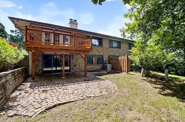 775 Knickerbacker Dr, Manchester, MO 63021 - rear view of property featuring brick siding, a patio, a chimney, and a wooden deck