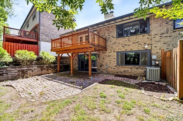 775 Knickerbacker Dr, Manchester, MO 63021 - rear view of house featuring a patio area, a chimney, brick siding, and a deck