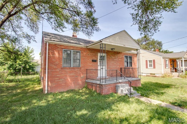 194 S Pence St, East Alton, IL 62024 - bungalow-style house with brick siding and a chimney
