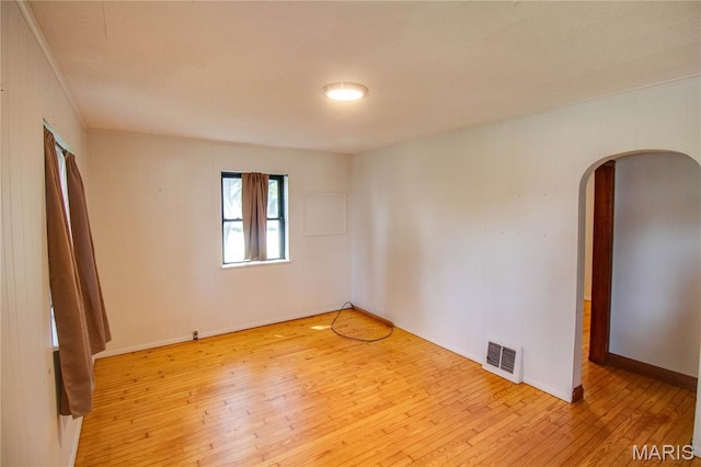 194 S Pence St, East Alton, IL 62024 - spare room with arched walkways, hardwood / wood-style floors, and ornamental molding