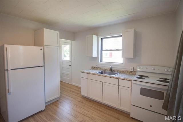 194 S Pence St, East Alton, IL 62024 - kitchen featuring white appliances, light wood-style floors, white cabinetry, and light stone counters