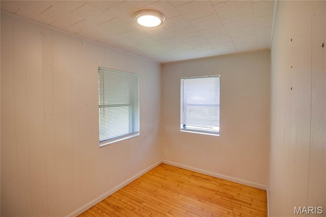 194 S Pence St, East Alton, IL 62024 - empty room featuring light wood finished floors and wood walls
