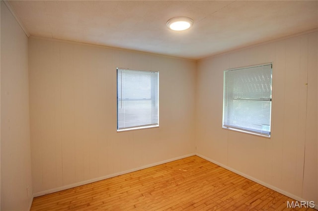 194 S Pence St, East Alton, IL 62024 - unfurnished room with crown molding, wood finished floors, and healthy amount of natural light
