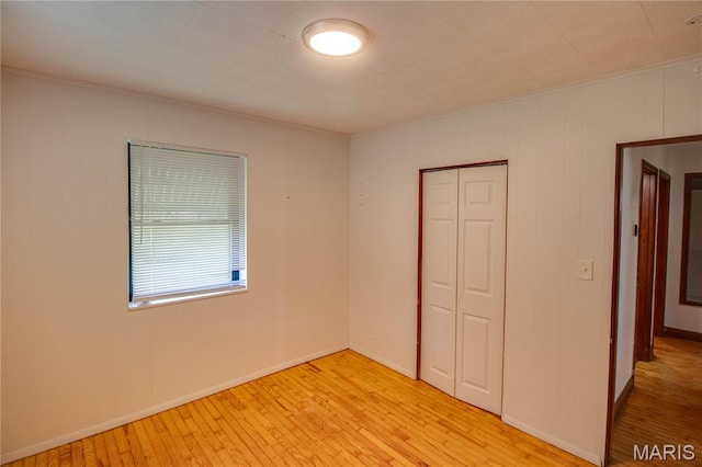 194 S Pence St, East Alton, IL 62024 - unfurnished bedroom featuring crown molding, a closet, and light wood finished floors