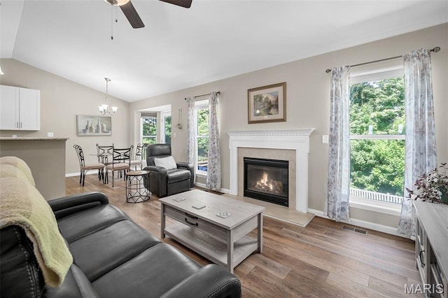 139 Brookview Way Dr, Ofallon, MO 63366 - living area featuring ceiling fan, vaulted ceiling, a chandelier, wood finished floors, and a high end fireplace