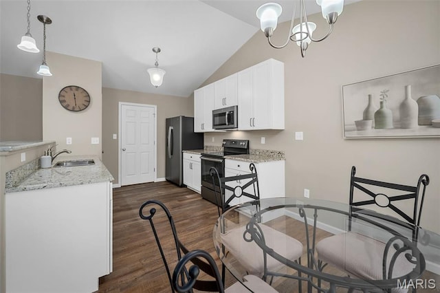 139 Brookview Way Dr, Ofallon, MO 63366 - kitchen with stainless steel appliances, dark wood-style floors, white cabinetry, a chandelier, and vaulted ceiling