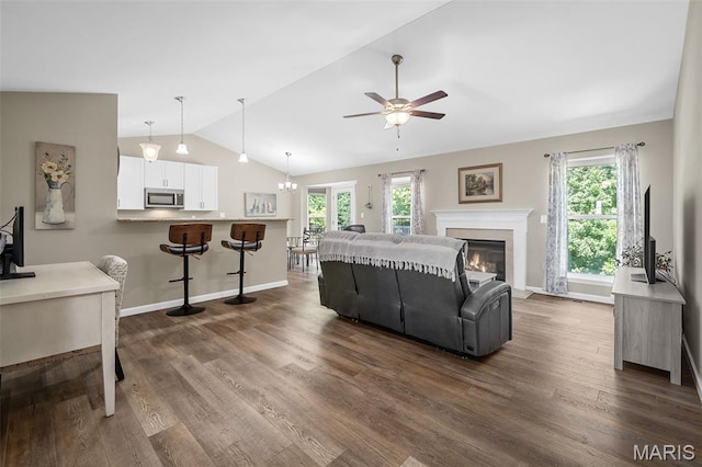 139 Brookview Way Dr, Ofallon, MO 63366 - living area featuring lofted ceiling, ceiling fan, dark wood-style floors, and a glass covered fireplace