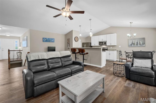 139 Brookview Way Dr, Ofallon, MO 63366 - living area featuring lofted ceiling, a ceiling fan, dark wood-type flooring, and a chandelier
