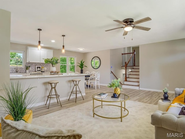 5 Chalet Ct, Fairview Heights, IL 62208 - living room with light wood finished floors, healthy amount of natural light, stairway, and ceiling fan