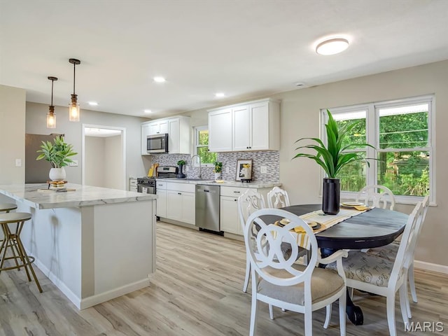 5 Chalet Ct, Fairview Heights, IL 62208 - kitchen with appliances with stainless steel finishes, light wood-style floors, backsplash, white cabinetry, and recessed lighting