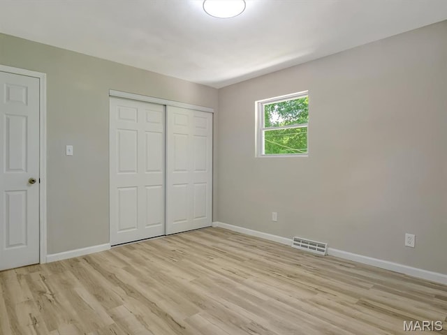 5 Chalet Ct, Fairview Heights, IL 62208 - unfurnished bedroom with light wood finished floors and a closet