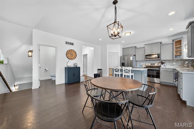 231 Flint Brook Dr, Ofallon, MO 63366 - dining room with a chandelier, dark wood-type flooring, and recessed lighting