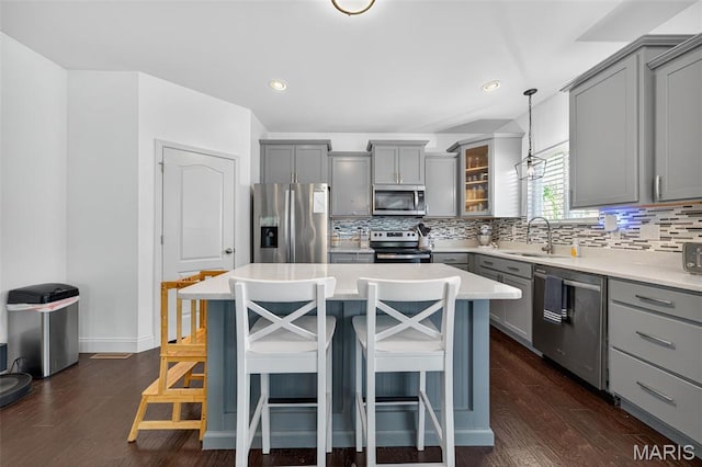 231 Flint Brook Dr, Ofallon, MO 63366 - kitchen with gray cabinetry, stainless steel appliances, tasteful backsplash, a breakfast bar area, and recessed lighting