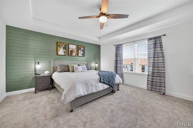 231 Flint Brook Dr, Ofallon, MO 63366 - bedroom featuring a tray ceiling, carpet, ceiling fan, and wood walls