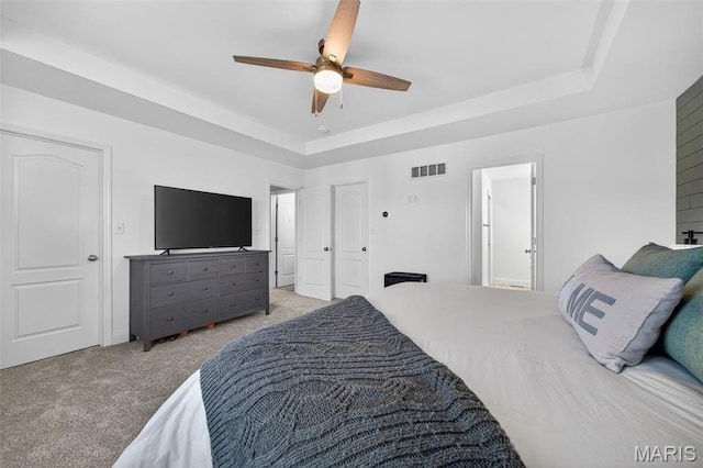231 Flint Brook Dr, Ofallon, MO 63366 - bedroom with a raised ceiling, light colored carpet, and a ceiling fan