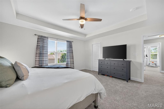 231 Flint Brook Dr, Ofallon, MO 63366 - bedroom featuring a tray ceiling, light colored carpet, and ceiling fan