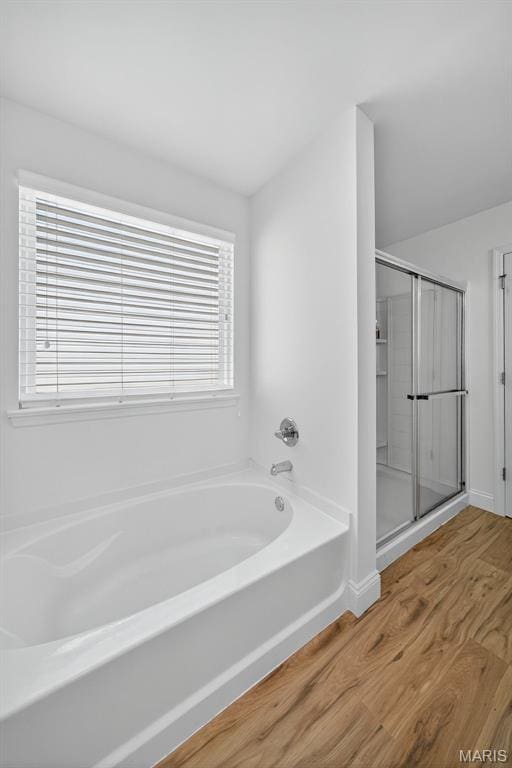 231 Flint Brook Dr, Ofallon, MO 63366 - full bath featuring wood finished floors, a garden tub, plenty of natural light, and a shower stall