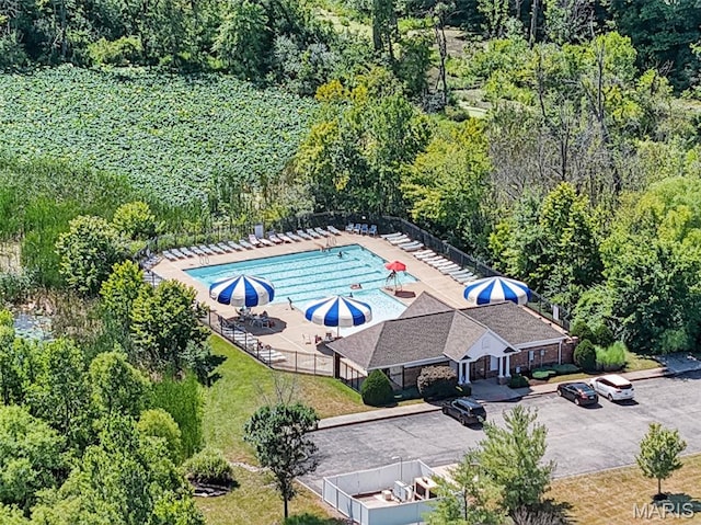 231 Flint Brook Dr, Ofallon, MO 63366 - bird's eye view of a pool and a heavily wooded area
