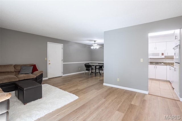 5593 Baronridge Dr Unit 7, Saint Louis, MO 63129 - living area featuring a ceiling fan and light wood finished floors