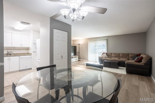5593 Baronridge Dr Unit 7, Saint Louis, MO 63129 - dining area featuring light wood-type flooring, a chandelier, and ceiling fan