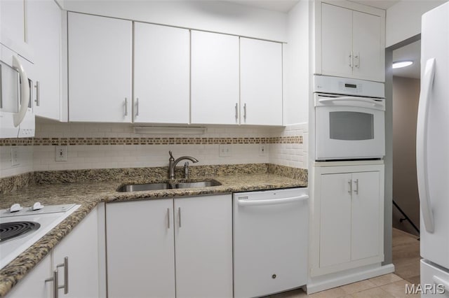 5593 Baronridge Dr Unit 7, Saint Louis, MO 63129 - kitchen with white appliances, white cabinets, tasteful backsplash, and light stone counters