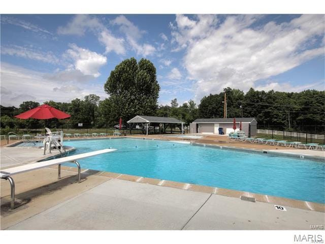 5593 Baronridge Dr Unit 7, Saint Louis, MO 63129 - community pool with a patio and view of wooded area