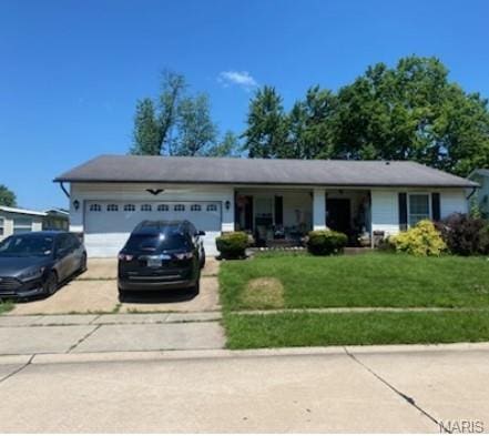 2921 Dividend Park Dr, Florissant, MO 63031 - ranch-style home with concrete driveway, a garage, and a front lawn
