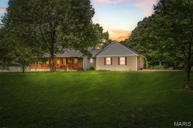 5090 Green Hills Rd, Festus, MO 63028 - back of property at dusk with a lawn and a garage