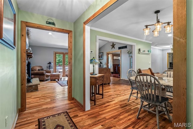 5090 Green Hills Rd, Festus, MO 63028 - dining area featuring wood finished floors, a chandelier, and crown molding