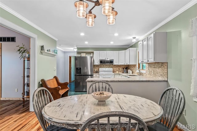 5090 Green Hills Rd, Festus, MO 63028 - dining area featuring crown molding, a chandelier, light wood finished floors, and recessed lighting