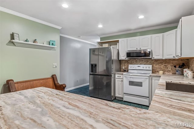 5090 Green Hills Rd, Festus, MO 63028 - kitchen featuring stainless steel appliances, white cabinets, tasteful backsplash, ornamental molding, and recessed lighting