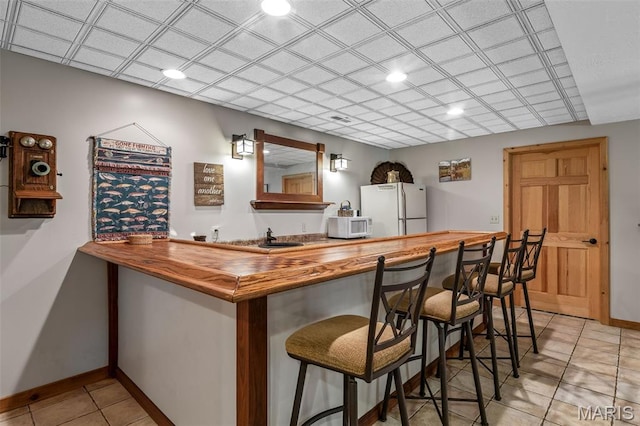 5090 Green Hills Rd, Festus, MO 63028 - indoor wet bar with white appliances, light tile patterned floors, and recessed lighting